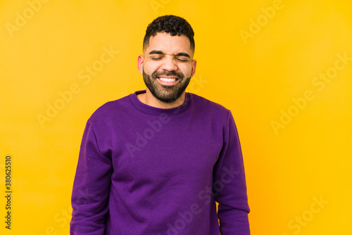 Wallpaper Mural Young mixed race arabic man isolated laughs and closes eyes, feels relaxed and happy. Torontodigital.ca
