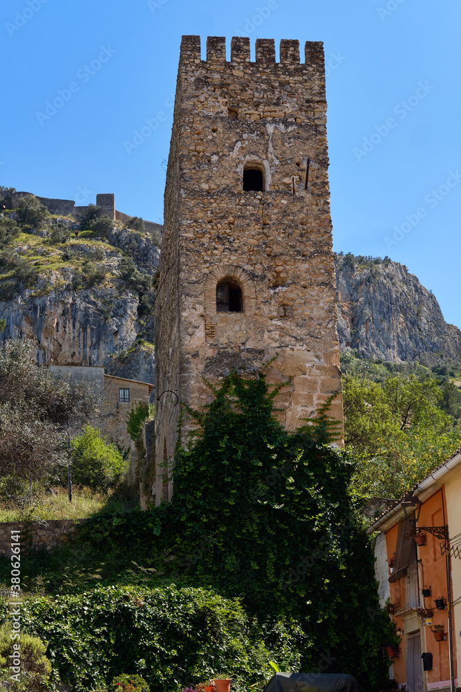 Famous historic buildings castle tower view against blue sky located on hill above the town of Xativa, Valencia, Spain
