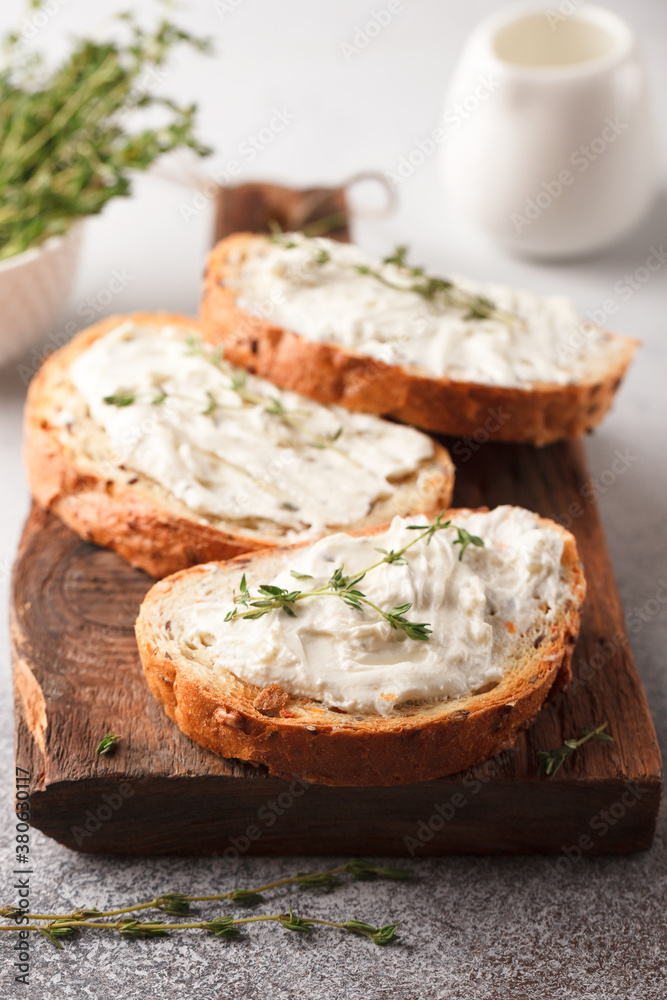Sandwiches with cheese and thyme. Lunch with toast. Toasts on a light background Sandwiches with cheese and thyme. Lunch with toast. Toasts on a light background