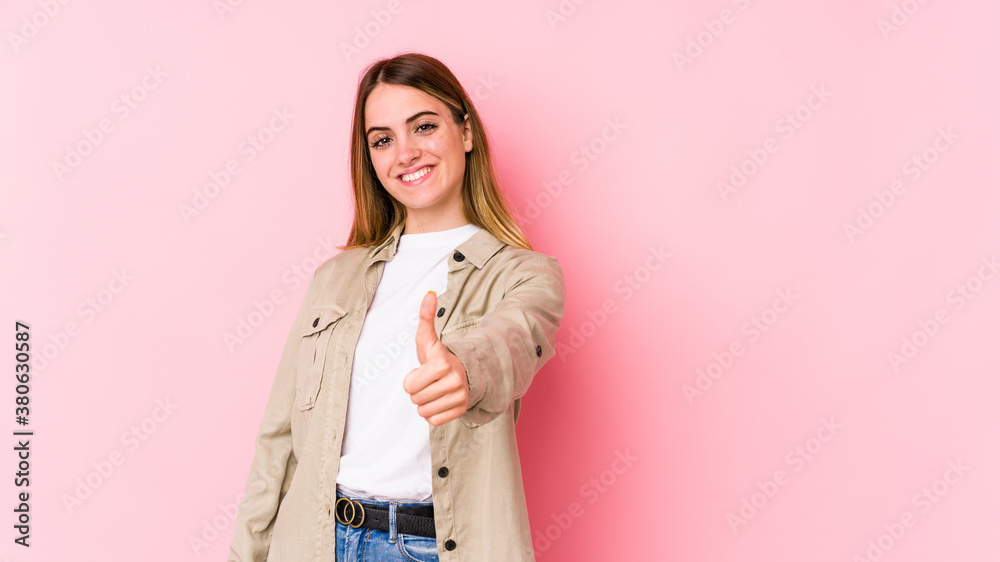 Young caucasian woman isolated on pink background smiling and raising thumb up Young caucasian woman isolated on pink background smiling and raising thumb up