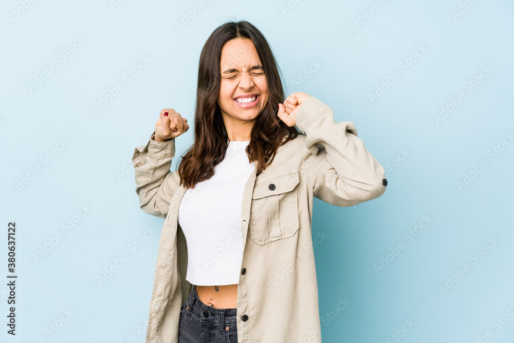 Young mixed race hispanic woman isolated stretching arms, relaxed position. Young mixed race hispanic woman isolated stretching arms, relaxed position.