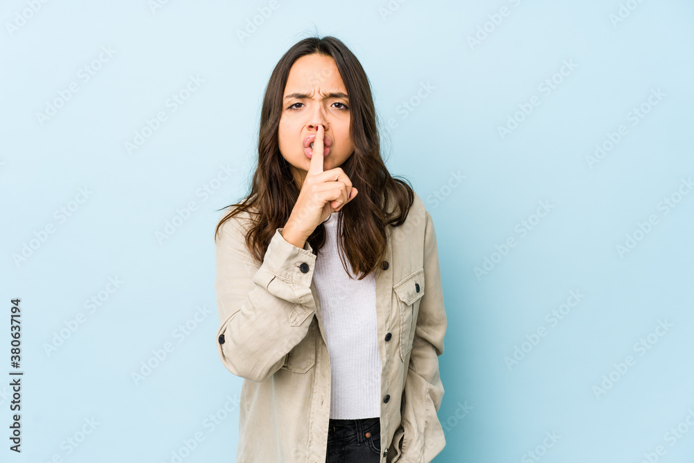 Young mixed race hispanic woman isolated keeping a secret or asking for silence. Young mixed race hispanic woman isolated keeping a secret or asking for silence.