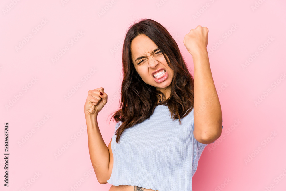 Young mixed race hispanic woman isolated showing strength gesture with arms, symbol of feminine power Young mixed race hispanic woman isolated showing strength gesture with arms, symbol of feminine power
