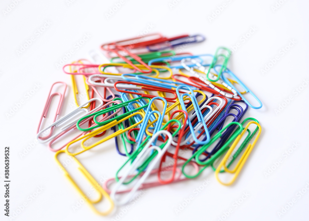 Colored paper clips close-up on a white background Colored paper clips close-up on a white background