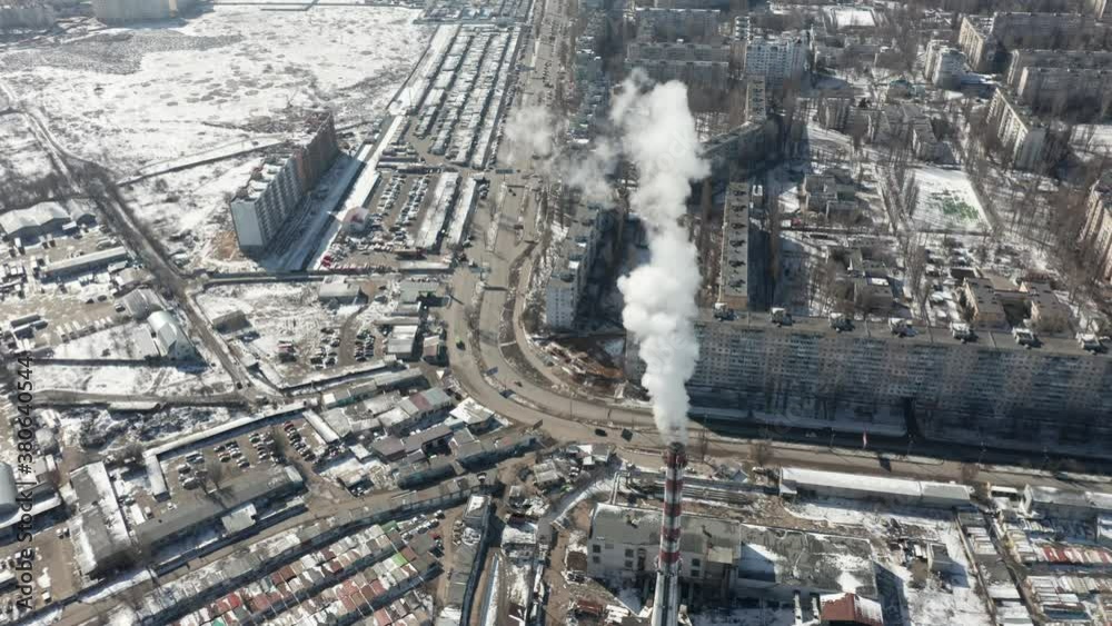 Video shot by a drone aerial view. Thick smoke comes from the industrial pipe of the power plant. Ecological problems of the big city. Environmental pollution by harmful industrial waste. Video shot by a drone aerial view. Thick smoke comes from the industrial pipe of the power plant. Ecological problems of the big city. Environmental pollution by harmful industrial waste.