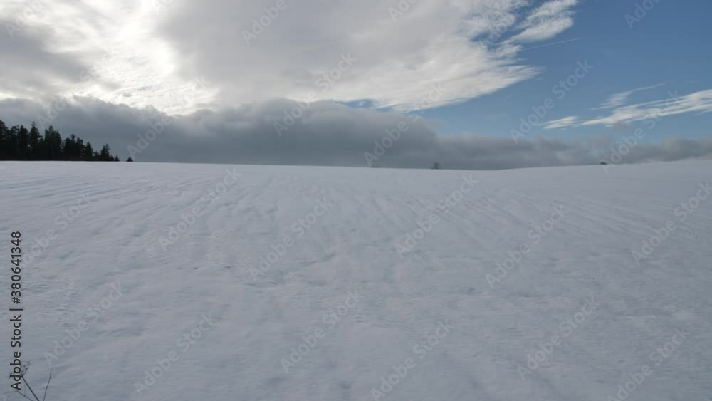 View of the winter hill covered with snow and surrounded by clouds.
View of the winter hill covered with snow and surrounded by clouds.
