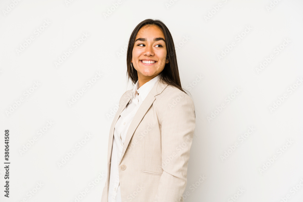 Young woman isolated on a white background looks aside smiling, cheerful and pleasant. Young woman isolated on a white background looks aside smiling, cheerful and pleasant.