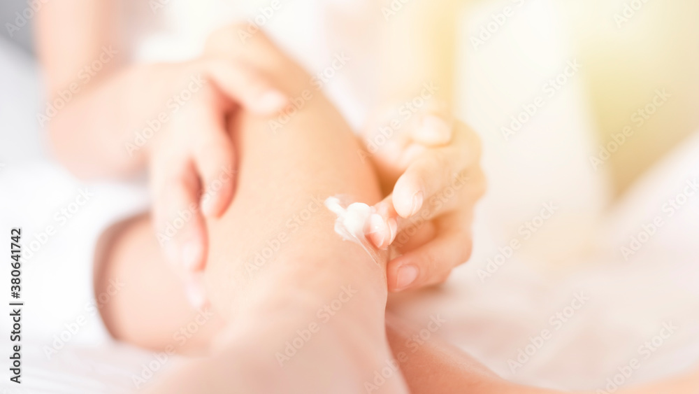 Naklejka premium Woman applying legs cream,lotion , Hygiene skin body care concept..