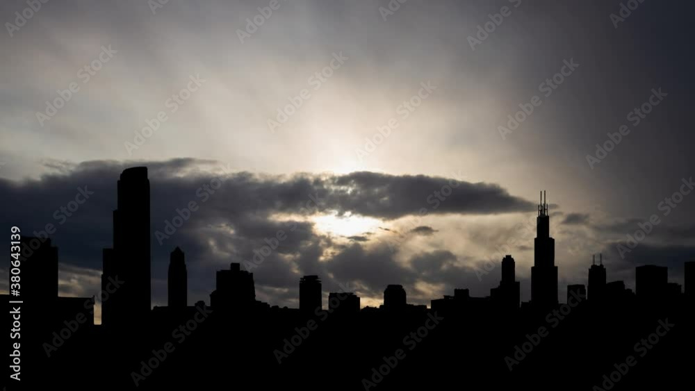 Chicago: Time Lapse at Sunrise with Fast Clouds and Dark Silhouette of Metropolis, USA Chicago: Time Lapse at Sunrise with Fast Clouds and Dark Silhouette of Metropolis, USA