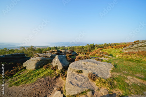 From the gritstone of Surprise View, over trees to a mist covered Derbyshire landscape © Steven Bramall