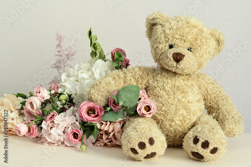 bouquet of delicate pink flowers and present box.Teddy bear. Valentines Day 14 February.Greeting card for Birthday, Woman or Mothers Day. I love you concept.Good morning.Selective focus.Copy space.