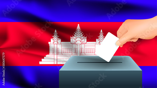 Male hand puts down a white sheet of paper with a mark as a symbol of a ballot paper against the background of the Cambodia flag. Cambodia the symbol of elections
