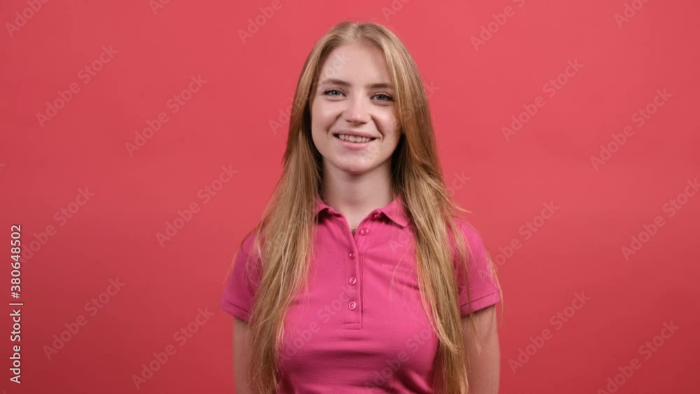 Close up of a pretty girl that is looking at camera with a smile, isolated on red background. Close up of a pretty girl that is looking at camera with a smile, isolated on red background.
