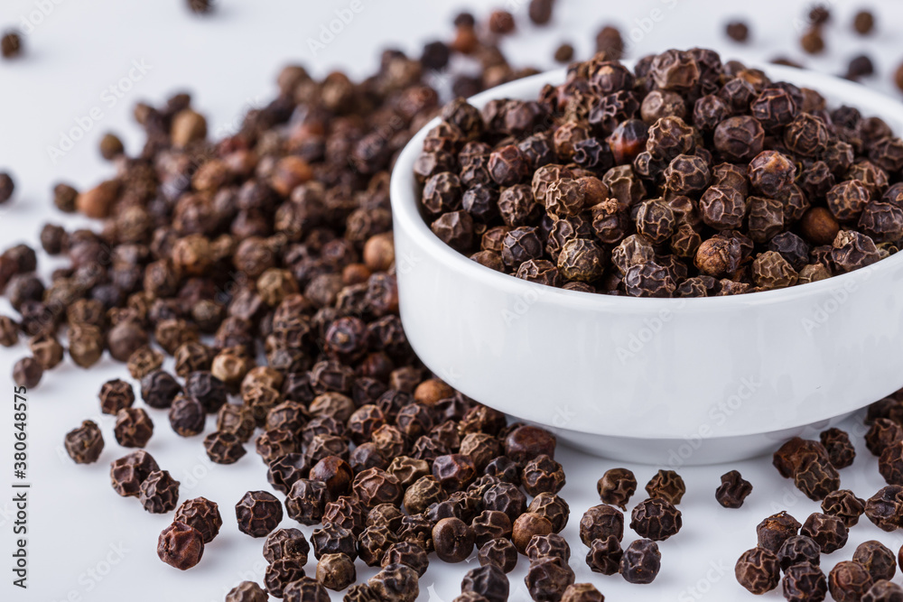 fragrant black pepper on white acrylic background fragrant black pepper on white acrylic background