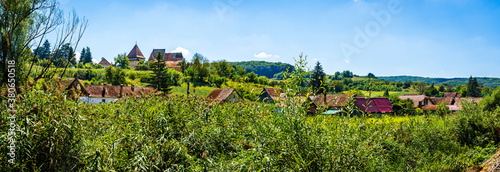 Panoramic view of traditional village and saxon evanghelical fortified church in Alma Vii, Sibiu county, Transylvania, Romania photo