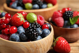 Mix of ripe berries in bowls, closeup