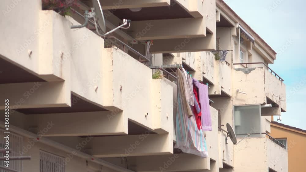 Towels Hanging of Balcony of an Older Apartment Building, drying in The Wind. Towels Hanging of Balcony of an Older Apartment Building, drying in The Wind.