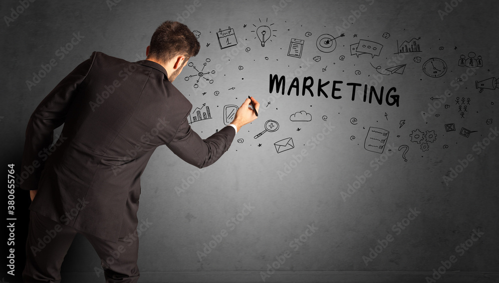 businessman drawing a creative idea sketch with MARKETING inscription, business strategy concept