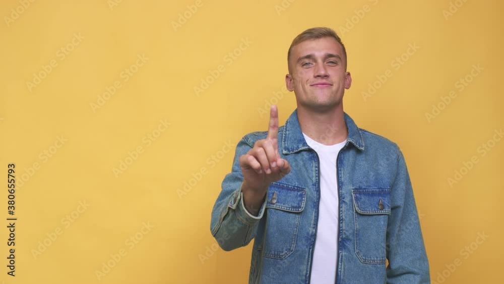 Young caucasian man showing number one with finger Young caucasian man showing number one with finger