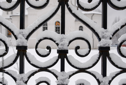 patten iron fence covered by snow