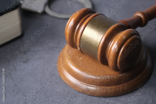  gavel, handcuff and book on table, close up 