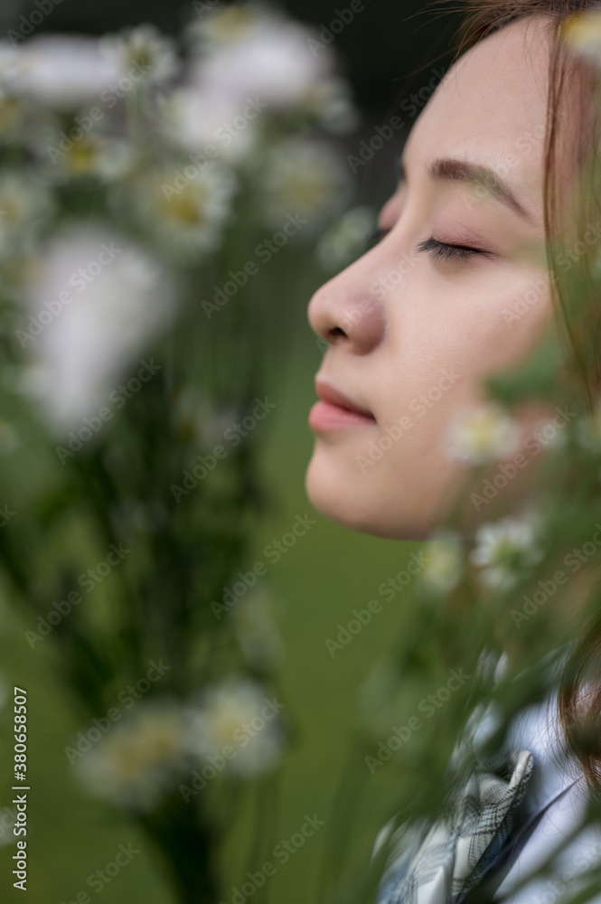 A young woman side face in flowers A young woman side face in flowers