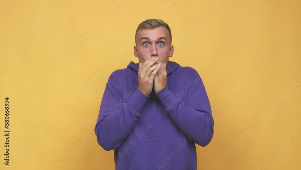 Young caucasian man shocked covering mouth with hands Young caucasian man shocked covering mouth with hands