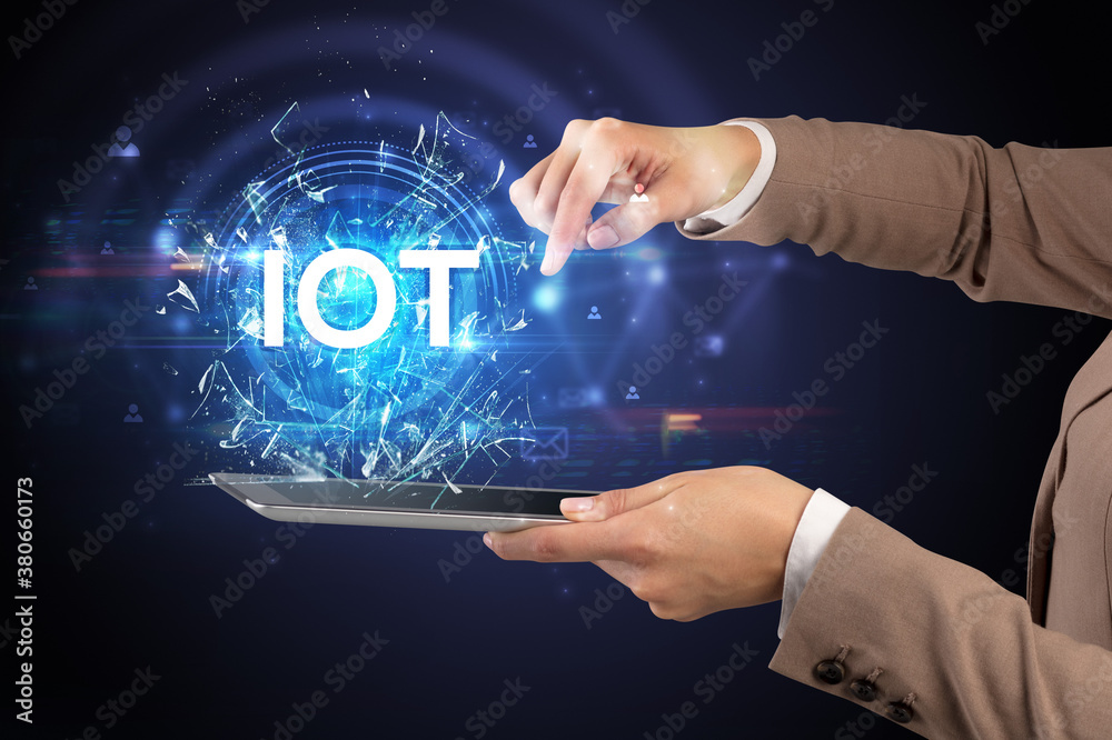 Close-up of a touchscreen with IOT abbreviation, modern technology concept Close-up of a touchscreen with IOT abbreviation, modern technology concept