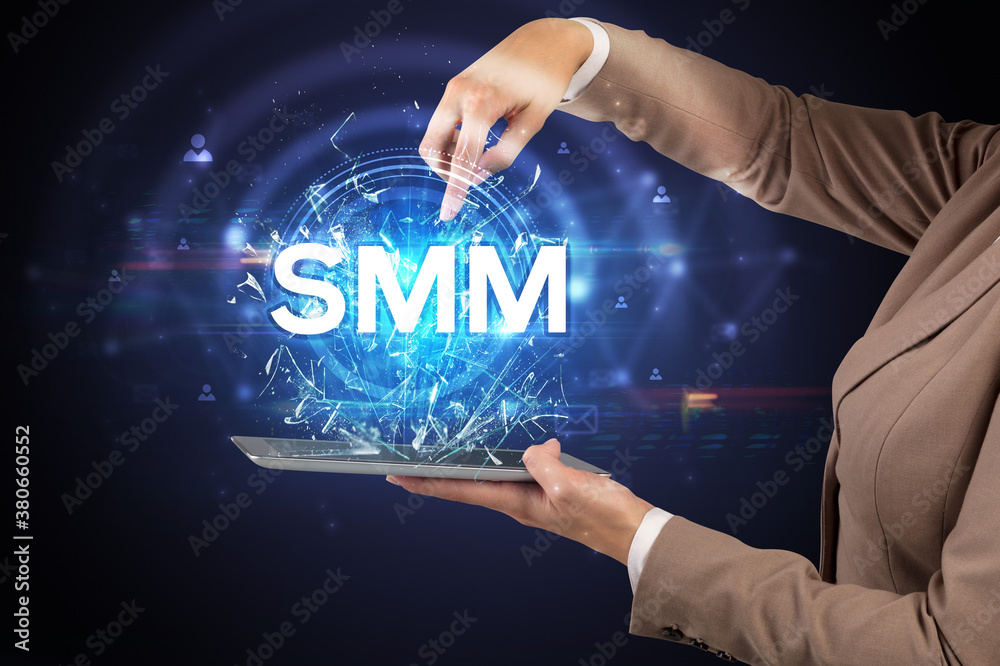 Close-up of a touchscreen with SMM abbreviation, modern technology concept