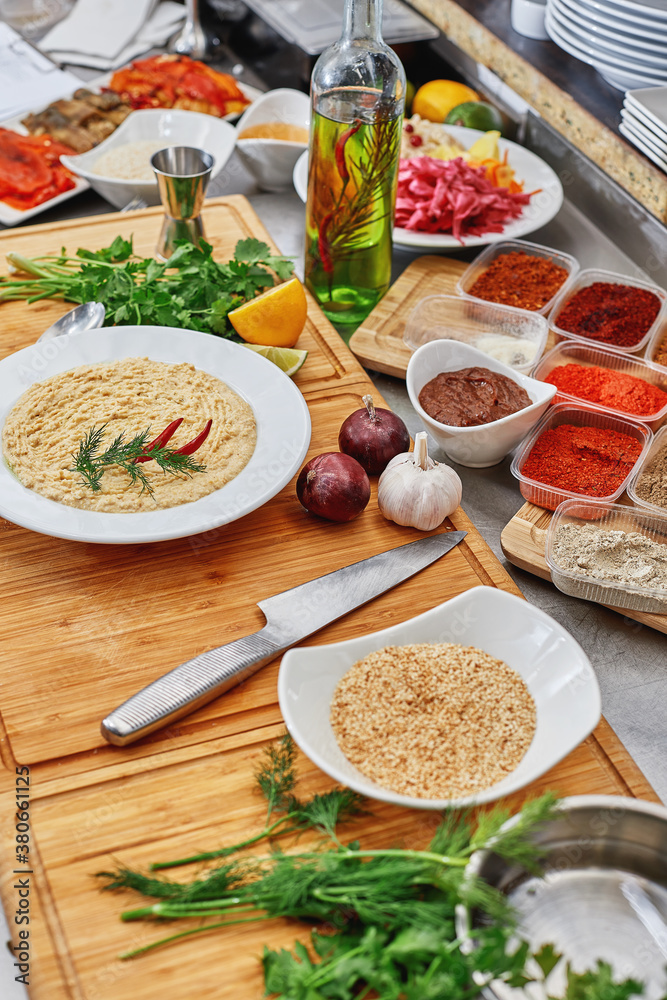 Many different spices, vegetables and ingredients, and fresh herbs for making homemade sauce