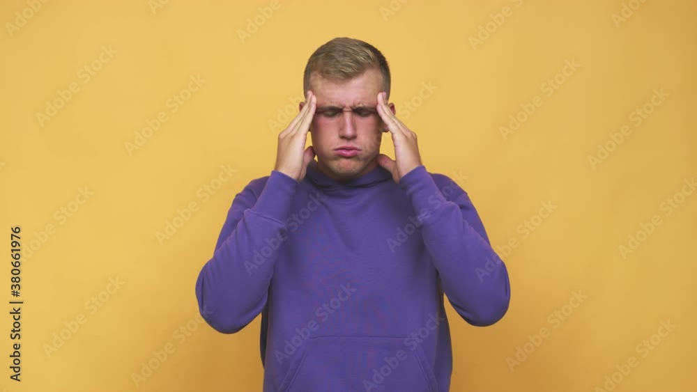 Young caucasian man touching temples and having headache Young caucasian man touching temples and having headache