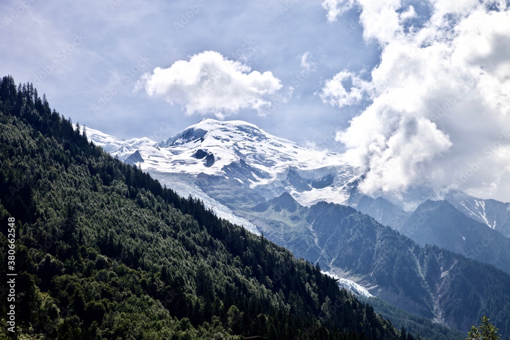 Mont Blanc Covered with snow and clouds. Single mountain peak. Snowy mountain peak. White mountain top on a cloudy day. Snow-covered white mountain peak. Mountains landscape. Climbing mountains.
