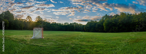 Panorama of a lawn field with lacrosse goals stored and locked together in Veteran's park in Lexington, KY USA during sunrise photo