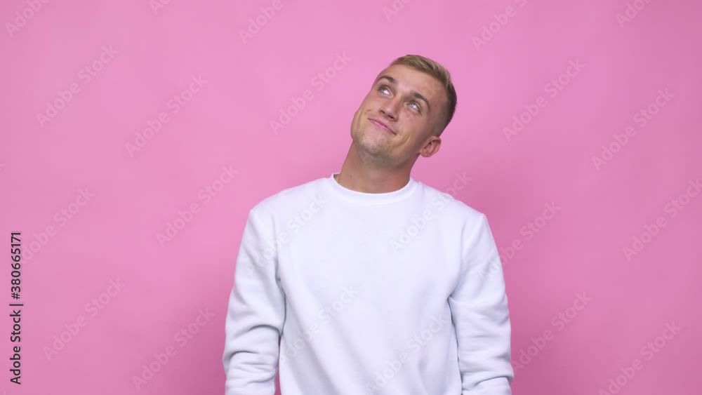 Young caucasian man dreaming of achieving goals and purposes