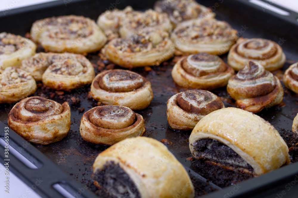 Baked buns stuffed with poppy, cinnamon and walnuts. Lie on a baking sheet. Cooking buns.