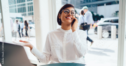 Cheerful businesswoman talking on smartphone photo