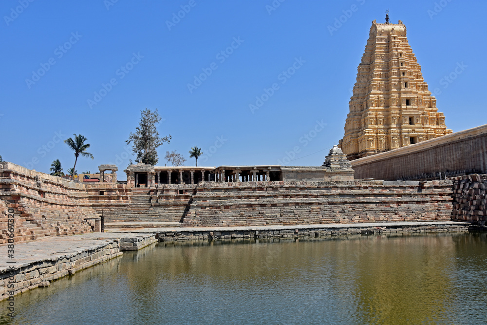 Virupaksha Temple view  from  backside with pond, located in the ruins of ancient city Vijayanagar at Hampi, India.