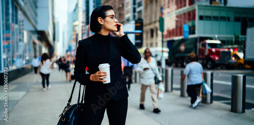 Stylish businesswoman negotiating by phone on street