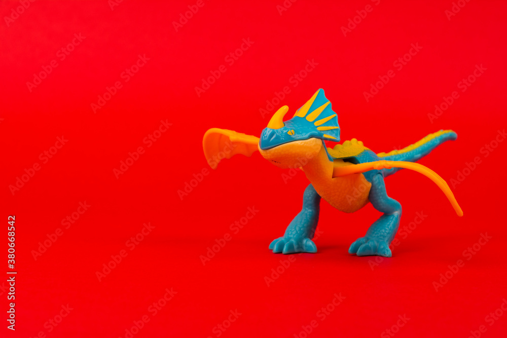 Dragon plastic kids toy isolated on a red background