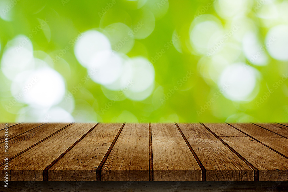 Empty wooden deck table with garden bokeh background. for product display montage. Empty wooden deck table with garden bokeh background. for product display montage.