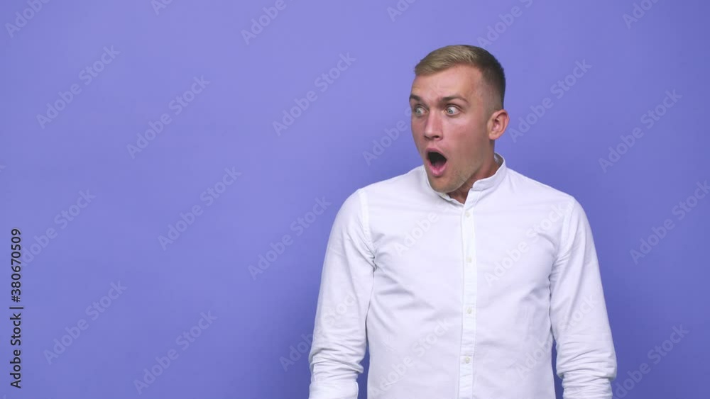 Young caucasian man being shocked because of something she has seen Young caucasian man being shocked because of something she has seen