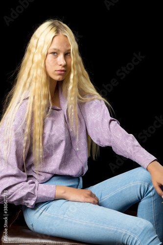 Close Up View of Cute Smiling Blonde Girl Posing on Black Background © lotosfoto