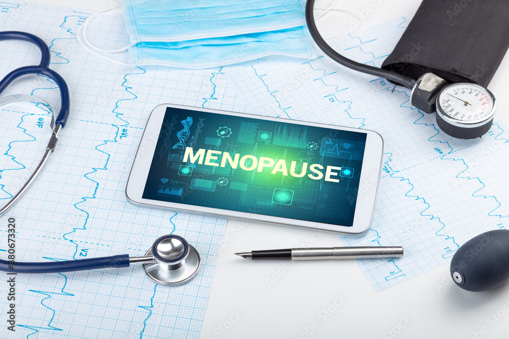 Tablet pc and medical stuff with MENOPAUSE inscription, prevention concept Tablet pc and medical stuff with MENOPAUSE inscription, prevention concept