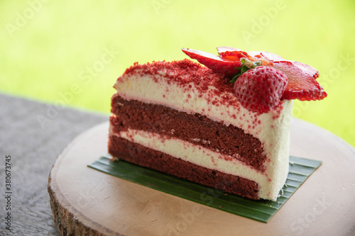 Red Velvet Cake with Fresh Strawberries Put on a round wooden tray instead of a plate.