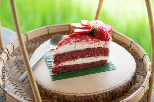 Red Velvet Cake with Fresh Strawberries Put on a round wooden tray instead of a plate.