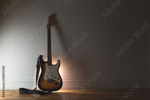 Music sound background with classic electro guitar and black cable on wall background photo