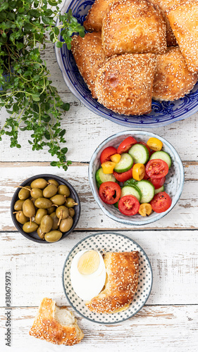 Plate with Burek, eggs, salad and Olives. Mediterranean style breakfast
