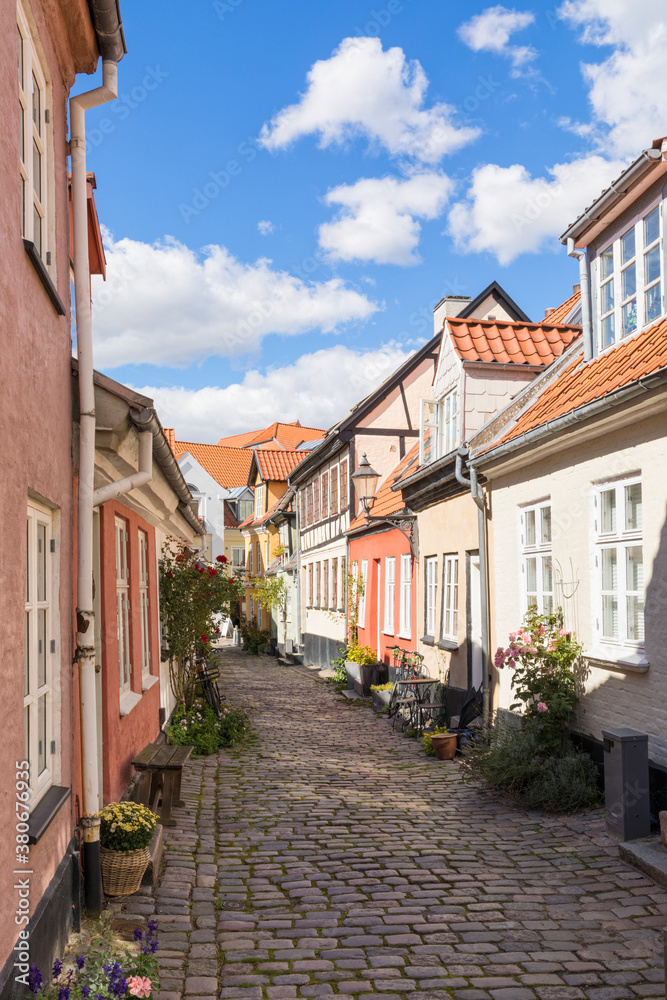 Idyllic street with old crooked houses at the old town of Aalborg, Denmark