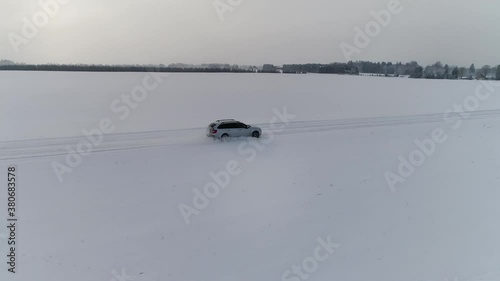 Car on a snowy winterroad. Shot by drone photo