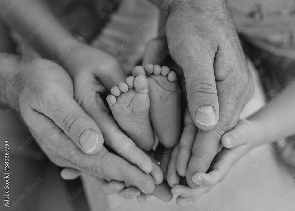 Feet of newborn surrounded by hands Feet of newborn surrounded by hands